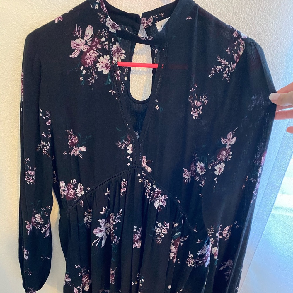 Black long sleeved blouse with floral detailing